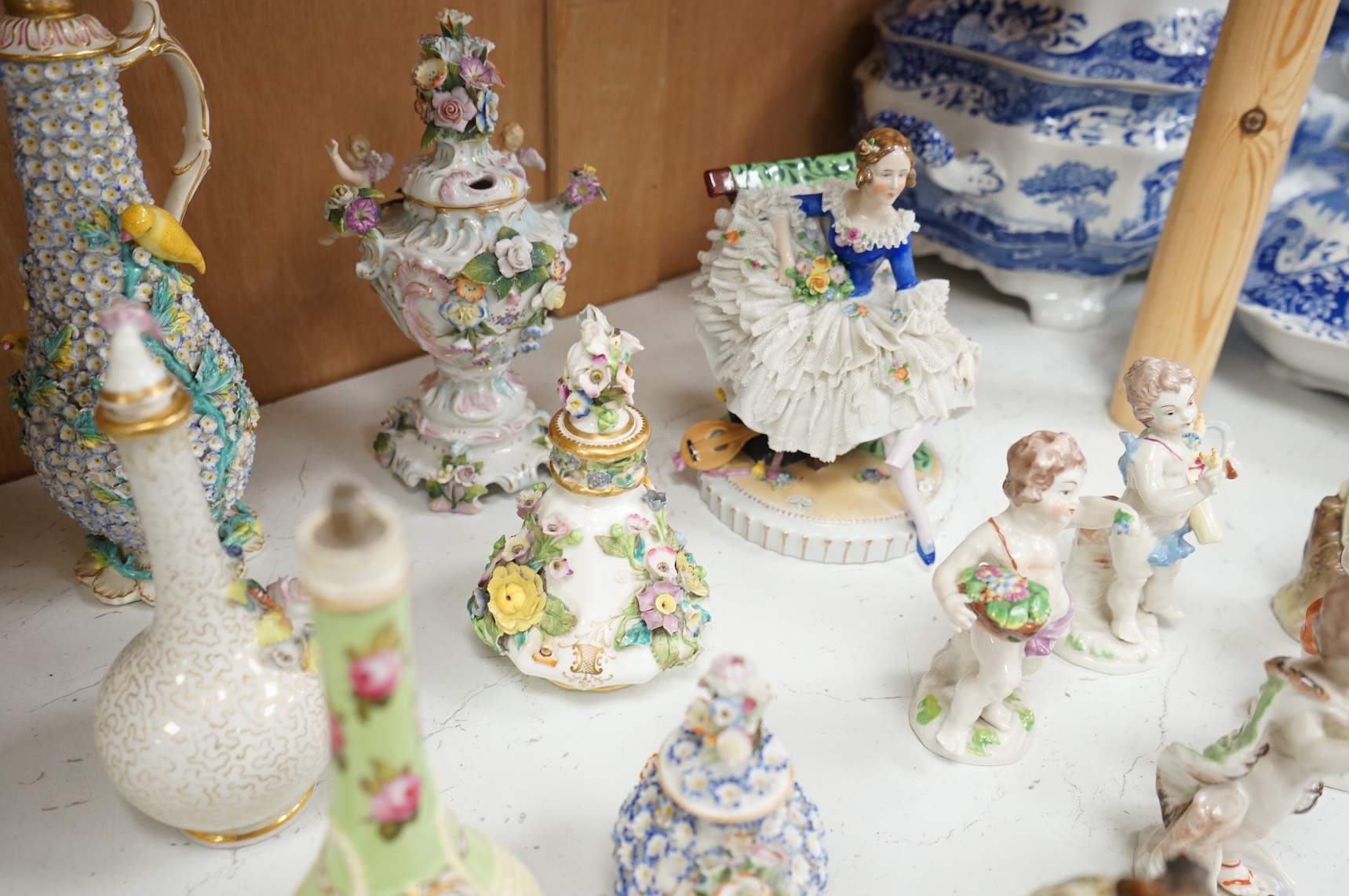 A group of English porcelain flower encrusted scent bottles and yours, Coalport, Minton etc., c.1830-50 together with Continental porcelain figures a wall pocket etc, largest 26cm high